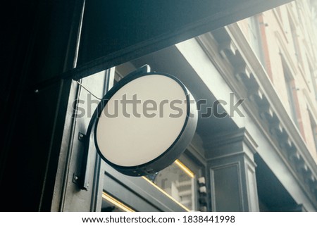 White round signage with blank space for your logo on the loft building wall, mockup