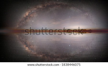 The milky way galaxy over the sea and  silhouette of rock in the night sky