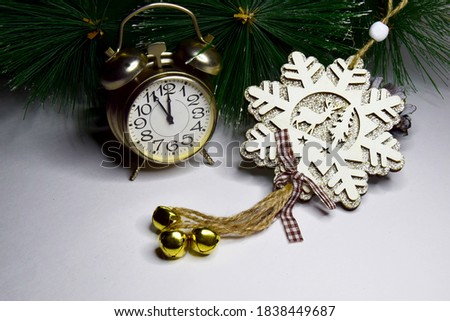 New Year clock Decorated with wooden snowflakes with sparkles and ornaments background. Christmas and New Years Eve celebration concept.