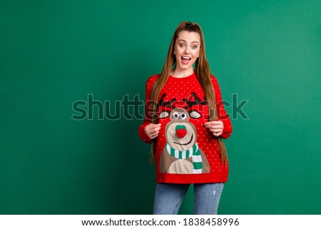 Portrait of her she nice-looking attractive pretty cheerful cheery long-haired girl demonstrating touching deer print sweater eve noel look outfit copy space isolated over green color background