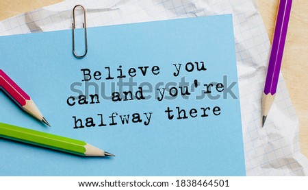 Believe you can and you're halfway there text written on a paper with pencils in office