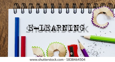 E-learning text written on a paper with pencils in office