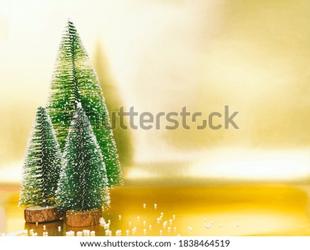 Christmas trees on a golden background. Copy space.