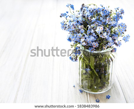 Bouquet of forget-me-not flowers in glass vase