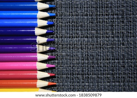 Wooden color pencils on a gray background with space for text