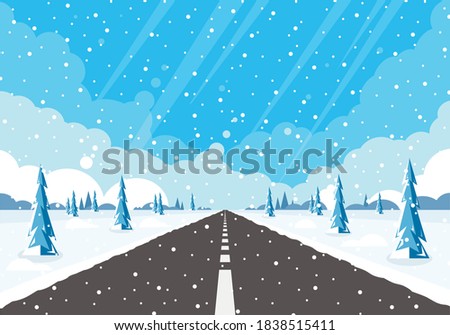 Winter road and falling snow. Rural winter landscape with trees and highway.