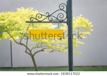 Yellow empty pole yard sign