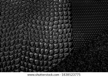 Decorative black reptile leather texture. Noisy black backdrop. Dark leather snake cloth. 