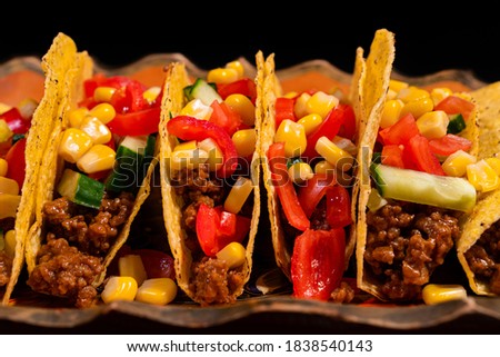 Delicious fresh tacos with cheese mexican food on a plate