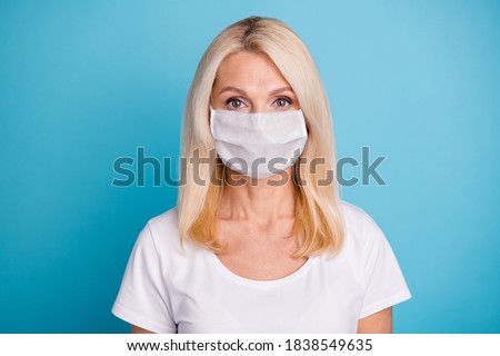 Photo of attractive middle age lady woman wear respirator casual white t-shirt isolated blue color background