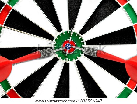 Close-up of a dart board with an imprinted flag of State of Tennessee in the center. The concept of achieving goals.