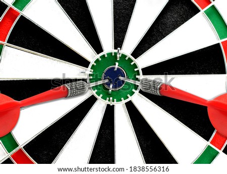 Close-up of a dart board with an imprinted flag of State of Alaska in the center. The concept of achieving goals.