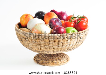 pedestal basket full of autumn fruits and vegetables