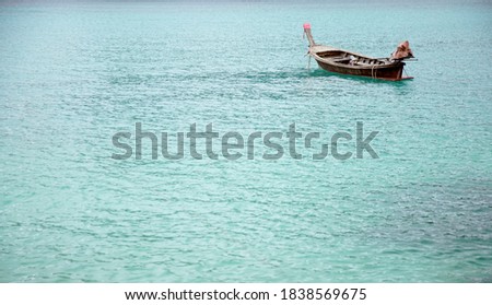 Alone Wooden boat floating on water blue sea ocean, copy space                                            