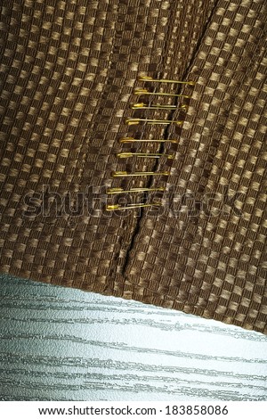 Safety pins on fabric background