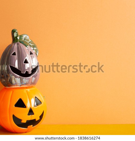 Halloween pumpkins on table with orange copy space