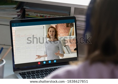 Close up rear view teenage student watching webinar at home, studying online, engaged conference, student listening to mentor teacher, sitting at desk, preparing to exam, homeschooling concept Royalty-Free Stock Photo #1838627851
