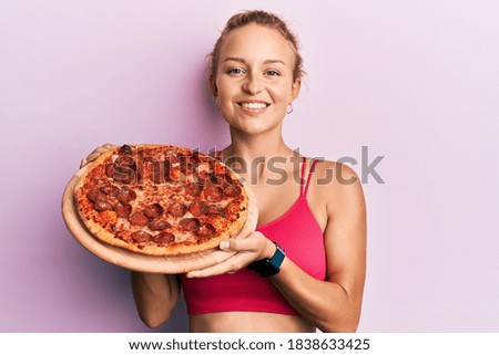 Beautiful caucasian woman holding italian pizza smiling with a happy and cool smile on face. showing teeth. 