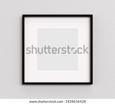 Black picture frame square shape on white wall. Blank Mockup