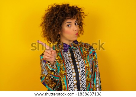 Woman gesturing a no sign. Closeup portrait unhappy, serious young woman dressed in generic design shirt raising finger up saying: oh no you did not do that. Negative emotions facial expressions.