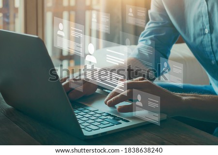 Human resource manager looking at many different cv resume and choosing perfect person to hire. HR concept on virtual screen. Royalty-Free Stock Photo #1838638240