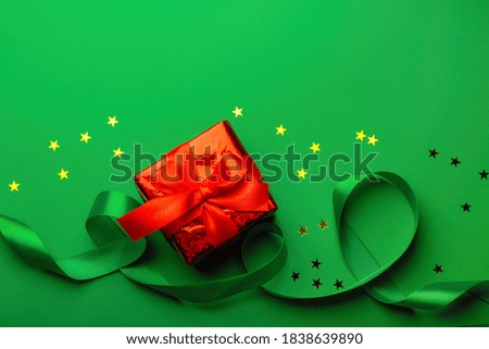 A New Year's background with New Year decorations on green background with stars and ribbon