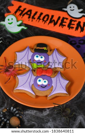 A couple (girl and boy) of funny, amusing  bat painted on honey gingerbread. Halloween food.