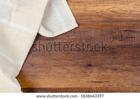 Tablecloth textile on wooden background.