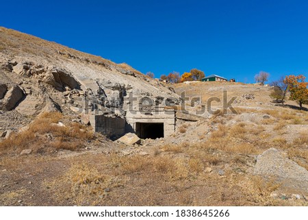 An old abandoned mine. Mine in the Karatau mountains. Mine poly metal plant. Karatau mountains in the south of Kazakhstan. Mountain plants in autumn. Rocks. Mountain stones. Dry grass, blue sky