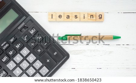 Global Leasing Day. calculator and pen on a beautiful background photo