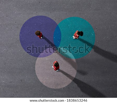 School children in uniforms standing on painted Venn Diagrams. It color is cyan, blue & white. Royalty-Free Stock Photo #1838653246