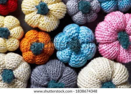 Texture from multicolored handmade crochet pumpkins for fall holidays decoration (Halloween, Thanksgiving Day)