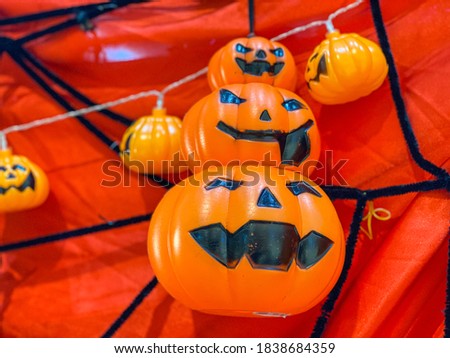 Plastic orange jack o lantern with spooky smile for halloween decoration