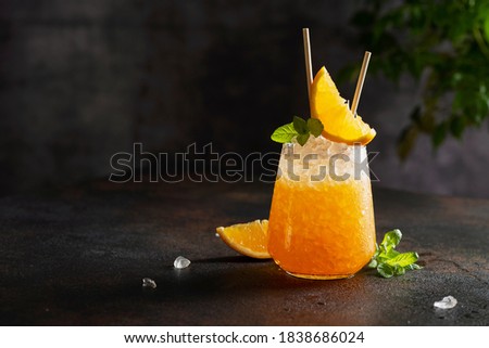 Fresh cold cocktial with orange, crushed ice and mint, selective focus image and bar concept Royalty-Free Stock Photo #1838686024