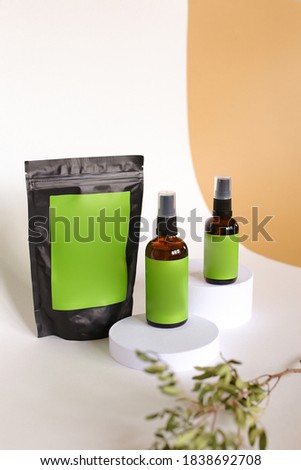 Close up doy pack and two spray bottles with cosmetic product, green space for your brand. Concept of cluelty free, organic, kosher cream and lotion is great for dry and rough skin.