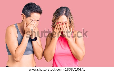 Couple of women wearing sportswear rubbing eyes for fatigue and headache, sleepy and tired expression. vision problem 