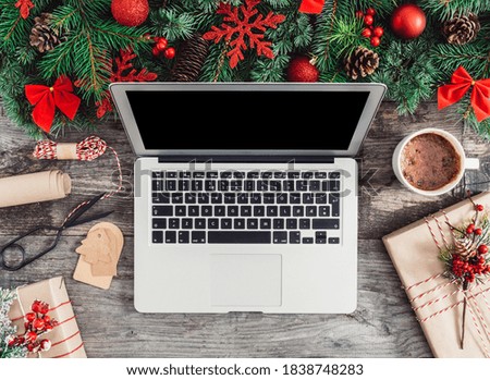 Laptop with blank screen on Christmas wooden background stock photo