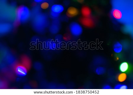 Abstract blur pattern of blue, green, red, yellow lights on isolated black background. Glitter texture christmas abstract backdrop. New Year light.