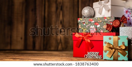 Panorama beautiful Christmas gift boxes presents on wooden background.