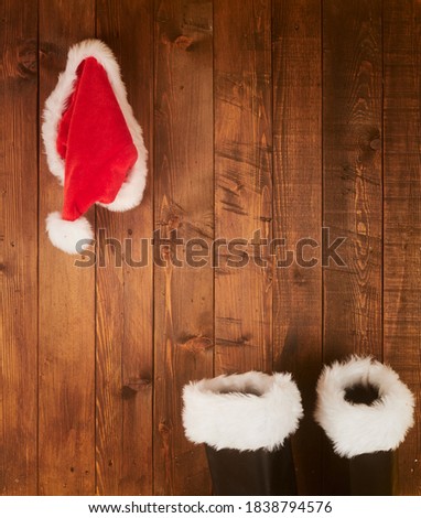 Santa Claus boots and hat  hanging on Wood wall