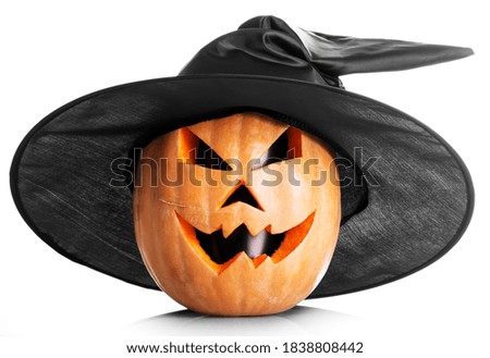 Handmade jack-o-lantern head with black eyes in a cap isolated on white background