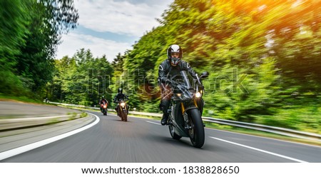 motorbike on the road riding. having fun driving the empty road on a motorcycle tour journey. copyspace for your individual text. Fast Motion Blur effect Royalty-Free Stock Photo #1838828650