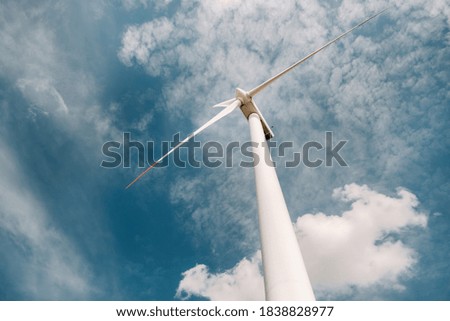 A white Windmill against a blue sky. Windmill in nature