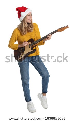 Young woman in Santa hat playing electric guitar on white background. Christmas music