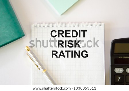 CREDIT RISK RATING abbreviation text, business concept image written on white sheet with pen, calculator and notepad. High quality photo