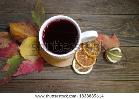 Hot fruit tea with lemon on a wooden background. Selective focus.Still life, food and drink, seasonal  concept.