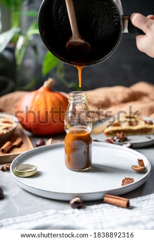Pumpkin spice latte syrup recipe pictures, cooking pumpkin spice latte homemade from scratch. Sweet tasty syrup with cinnamon, ginger, nutmeg,  cloves and cardamom. Thanksgiving holidays fall beverage Royalty-Free Stock Photo #1838892316