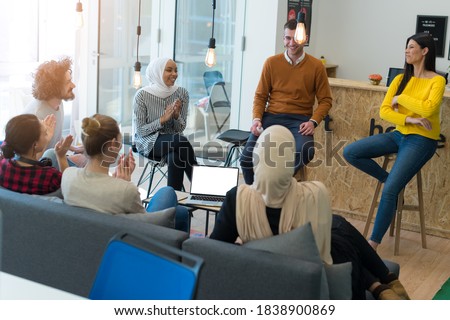 Successful team. Group of young business people working and communicating together in creative office Royalty-Free Stock Photo #1838900869