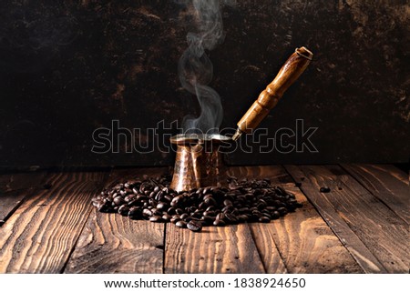 Turkish Coffee Pot and Coffee, on wooden background.- image