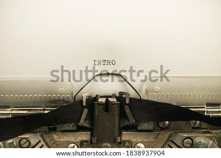 to type text intro on a vintage and old typewriter close-up Royalty-Free Stock Photo #1838937904